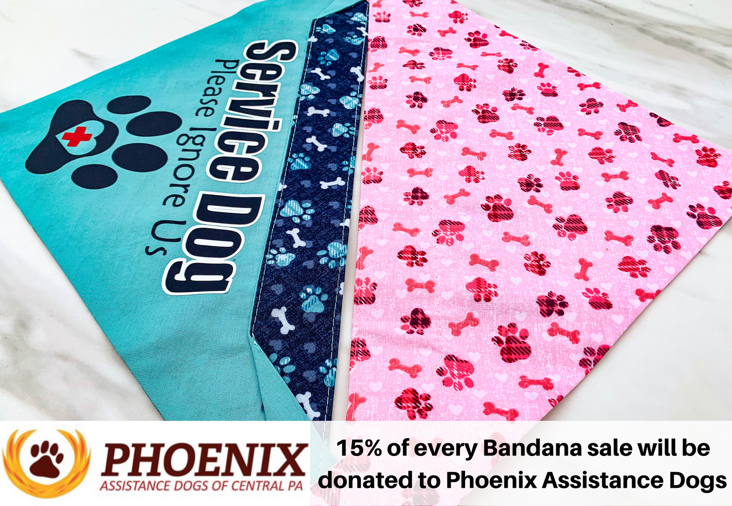 Blue and pink bandanas are shown. Blue is on the left face up with an ignore us paw design. The right is reverse side up it looks like redish pink and black plaid paws and redish pink bones on pink background with light pink hearts. Text at the bottom says 15% of every bandana sale will be donated to Phoenix Assitance Dogs.