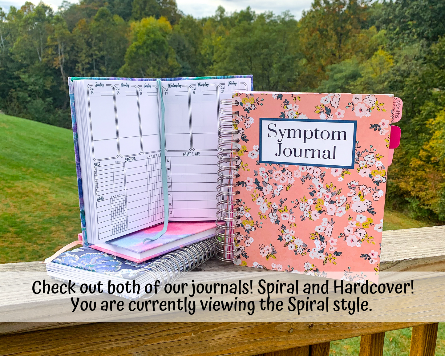 A hardcover book is shown open sitting on top of another hardcover book in pink, and a blue spiral bound book. A large pink spiral bound book is shown closed to it's right with a label that says Symptom Journal. A note says check out both of our journals Spiral and Hardcover. You are currently viewing the spiral style.