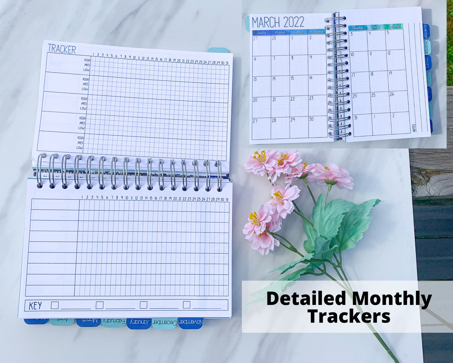 Detailed Monthly Tracker. A book is shown open sideways on a marble surface. The top page says Tracker. There are 5 large boxes with a grid numbered 1 to 31 next to it. Each horizontal line of the grid is labeled low, medium, high. The bottom page's box has 9 rows. Next to the blank area for writing are boxes labeled 1 to 31. It is not a grid. There is a box at the bottom that says Key and has 4 boxes with lines next to each. A photo of the calendar page is in the upper right corner.