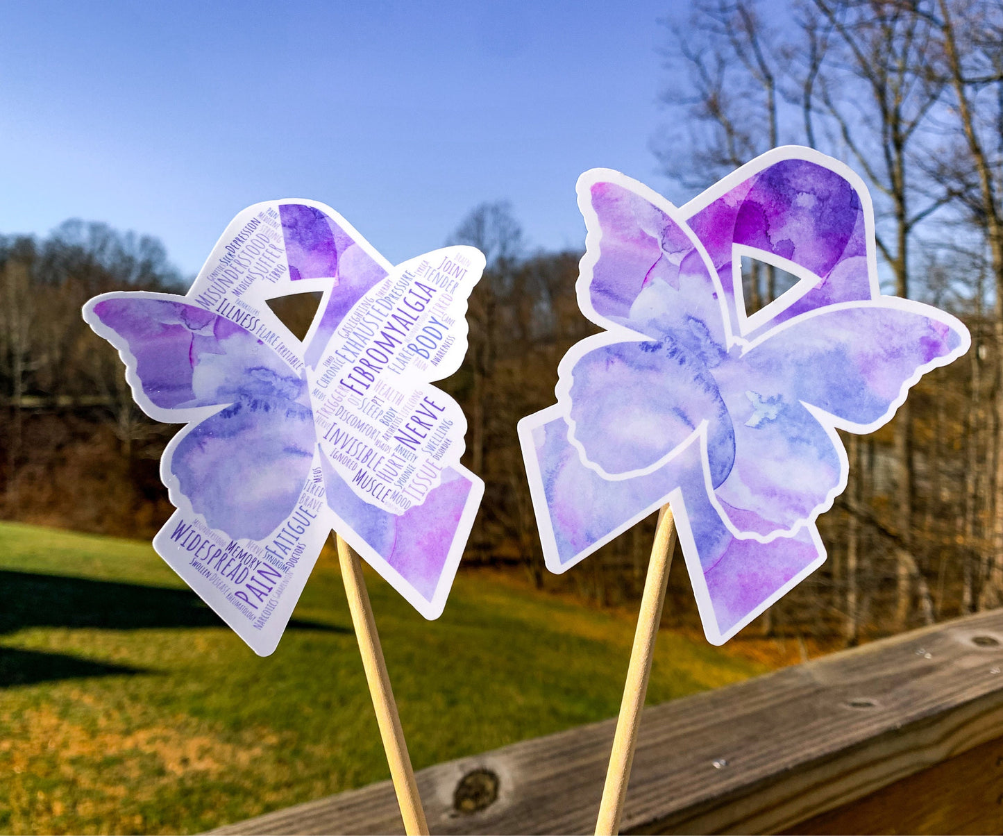 The word cloud and watercolor designs are shown on 2 sticks. Both ribbons feature a purple color awareness ribbon with a butterfly in the center. The word cloud design on the left is split in half with a word cloud on the left half of the ribbon and right half of the butterfly.