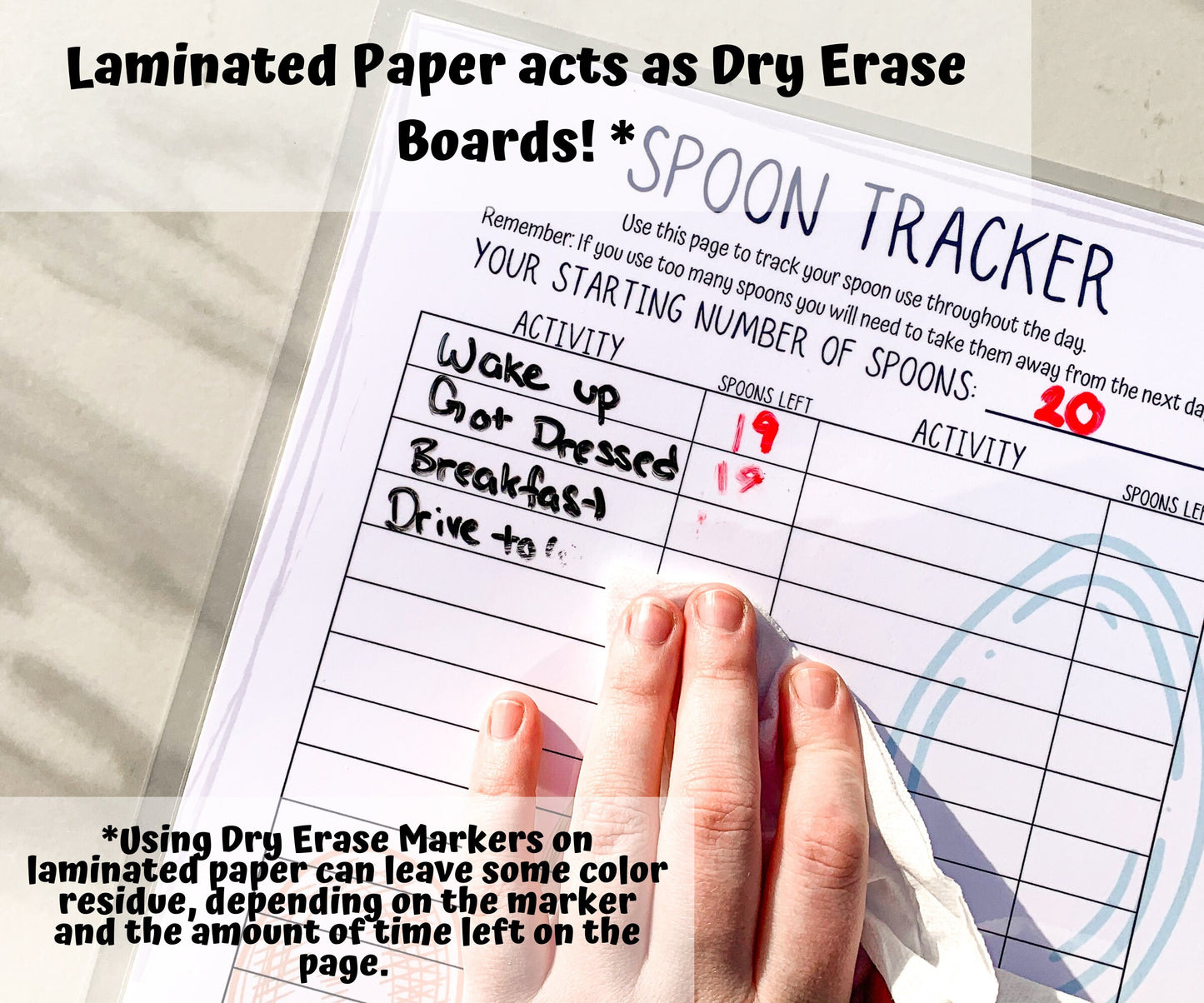 A laminated spoon tracker is shown with activities and spoon number written but being erased with a tissue. A note says Laminated paper acts as a dry erase board, using dry erase markers on laminated paper can leave some color residue, depending on the marker and the amount of time left on the page.