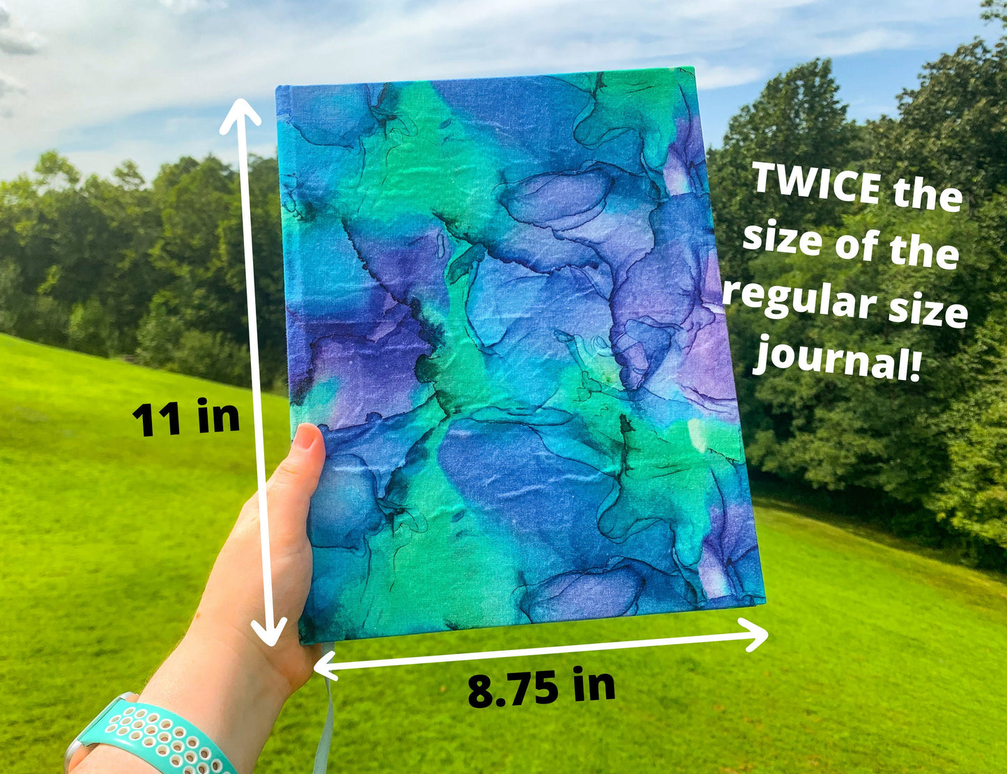 The large print journal closed is shown being held up. Measurements shown say it is 11 inches tall by 8 3/4 inches wide. Twice the size of the regular size journal.