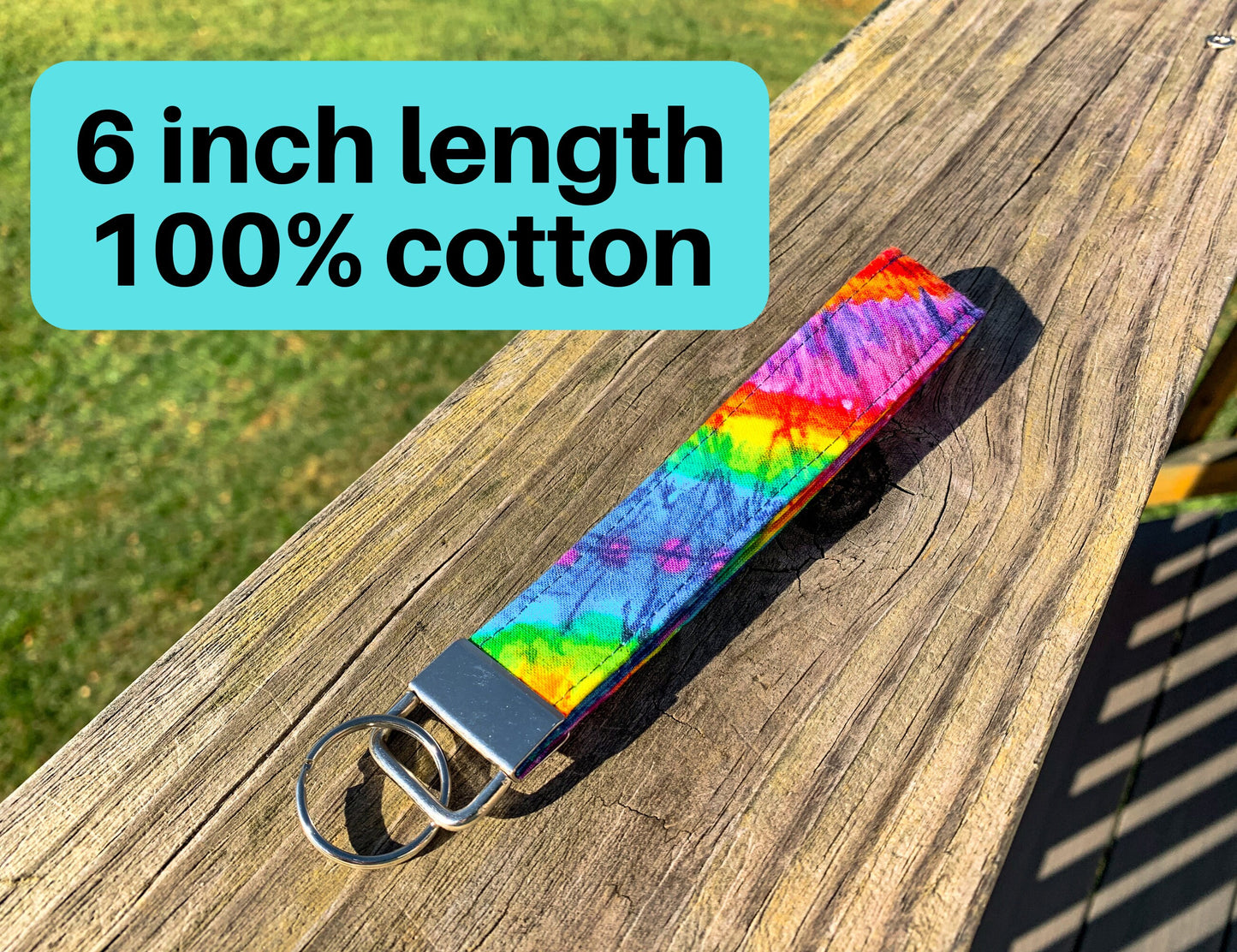 The tie dye wristlet is shown on wood. A box says 6 inch length 100 percent cotton.