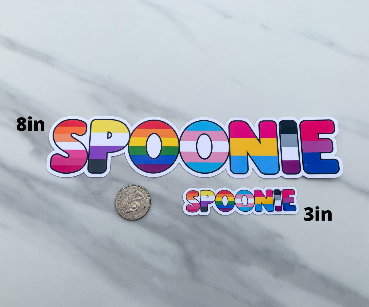 The 8 inch and 3 inch sticker are shown next to each other for comparison. There is a quarter below the 8 inch sticker and left of the 3 inch sticker.