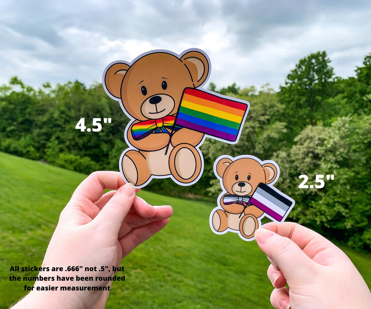 A 4 1/2 inch and 2 1/2 inch sticker are shown held up next to each other for comparison. The 4 1/2 inch sticker has a rainbow pride flag, the bow tie is a matching rainbow gradient. The 2 1/2 inch sticker has a asexual flag with a matching gradient bow tie. A note says all stickers are .666 inch not 1/2 inch but the number have been rounded for easier measurement.