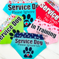 5 service dogs bandana on a marble slab. The bandanas are in the colors aqua, green, red, pink, and blue.