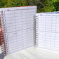 The larger pink and smaller blue books are being held up. They show the same 1 page. There are 2 boxes. The top one has columns labeled Allergy, reaction, onset, other. It has 7 rows. The bottom box has the same number of columns and rows but has blank slots to record whatever you want. The books have matching pink or blue shadows behind the text.