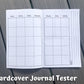 The calendar page of the hardcover journal is shown. There are 7 columns, 5 rows deep of squares with no dates. At the top of each column are the days of the week, but no color background. On the right page next to the box of squares you there are 3 vertical lines lining perpendicular to the way info would be written in the boxes. Notes is written on the left of the top line when facing to write.