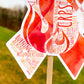 A close up of the bottom part of the ribbon of the word cloud design. You can see the words clearly in matching shades of orange and red. The words are things like Burning, Aching, Misunderstood, Swelling, Fatigue, Therapy, CRPS, Skin, Fire, Sadness, Sharp, Pain Management, and more.