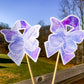 The word cloud and watercolor designs are shown on 2 sticks. Both ribbons feature a purple color awareness ribbon with a butterfly in the center. The word cloud design on the left is split in half with a word cloud on the left half of the ribbon and right half of the butterfly.