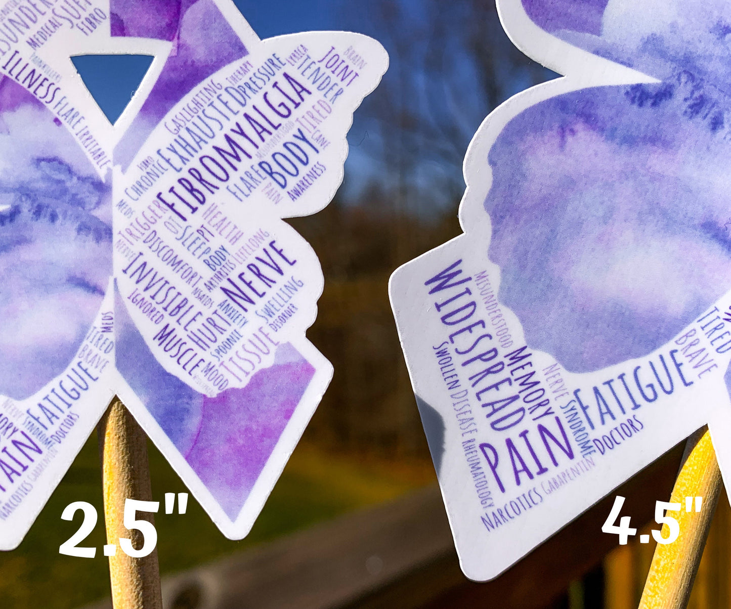 A close up of the 2.5 and 4.5 in word cloud ribbons are shown. You can see the words clearly in matching shades of purple. The words are things like Nerve, Widespread, Memory, Fatigue, Chronic, Fibromyalgia, Tissue, Spoonie, Pressure, Gaslighting, Illness, Flare, Misunderstood, Disease, and more. 