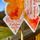 A close up of the 4.5 in word cloud ribbon is shown. You can see the words clearly in matching shades of orange. The words are things SPMS, Varied, Everyone is Different, Memory Loss, Frustration, Life-Long, Unpredicatable, Dizziness, MS, Misunderstood, Pain, and more.
