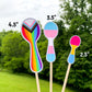 3 Pride Spoon stickers are shown on sticks. The 4.5 inch progressive pride flag- that has vertical rainbow lined, squished at the neck of the spoon. It also has triangles of the trans pride colors and brown and black at the top. The 3.5 inch transgender pride spoon has blue pink white pink blue stripes horizontally. The 2.5 inch pansexual pride spoon has hot pink yellow and blue stripes horizontally.