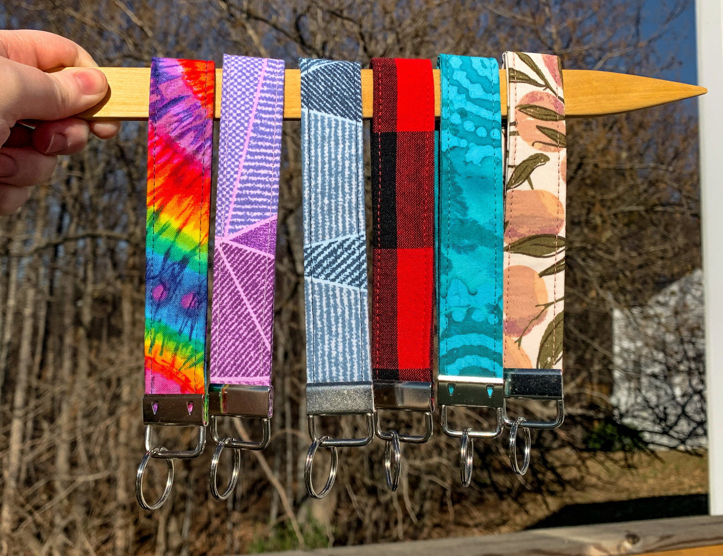 6 more wristlets are shown, in the colors Tie Dye, Pink Geo, Blue Geo, Red Plaid, Unlisted, Mauve Peach