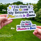 The same 7 inch non binary sticker is shown again next to a 4 inch Bisexual flag colored I'm Here I'm Queer My Migraines are Moderate to Severe sticker, this one does not have sparkles. A note says sizes are approximate, may vary based on text requested.